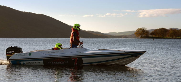 A power boat in morning light with driver ready to race